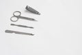 Metal manicure set, tweezers, scissors, file and spatula on white background, copy space Royalty Free Stock Photo