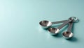 Metal Measuring Spoons on Blue Surface Royalty Free Stock Photo