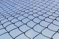 Metal mesh close-up against the blue sky. The concept of freedom and peace Royalty Free Stock Photo