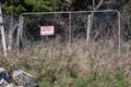 Metal mesh fence with sign private property no trespassing. Security and safety concept Royalty Free Stock Photo