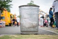 A metal mesh garbage trash can in a public place Royalty Free Stock Photo