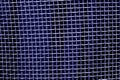 Metal mesh grid pattern in blue tone. Royalty Free Stock Photo