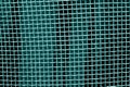 Metal mesh grid pattern in cyan tone. Royalty Free Stock Photo