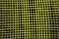 Metal mesh grid pattern in yellow tone. Royalty Free Stock Photo