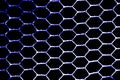 The metal mesh grille is hexagonal. View from the front by the light on a black background Royalty Free Stock Photo