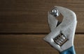 Monkey wrench with and nut on wood background Royalty Free Stock Photo