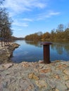 Metal mooring boat pole, on the river bank Royalty Free Stock Photo