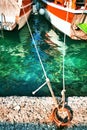 A metal mooring ring and two anchored yachts at the pier Royalty Free Stock Photo