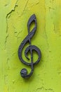 Metal Music Note Hanging on Yellow Wall