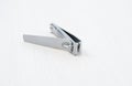 Metal nail clippers for manicure on a white background. Royalty Free Stock Photo