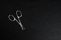 metal nail scissors on a black textured background Royalty Free Stock Photo