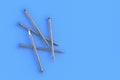Metal nails on blue background. Building equipment. Tool for repair, renovation. Top view. Copy space
