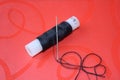 Metal needle with black thread pinned into small bobin Royalty Free Stock Photo