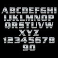 Metal numbers, symbols and letters on a black background.