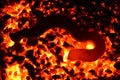 The metal object is heated on anthracite coal. Royalty Free Stock Photo