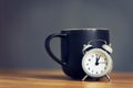 Metal old alarm clock with coffee cup Royalty Free Stock Photo
