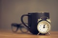 metal old alarm clock with coffee cup Royalty Free Stock Photo