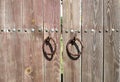 Metal old rusty round handle on wooden doors Royalty Free Stock Photo