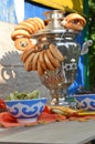 Metal old traditional russian samovar for tea drinking. Brewing tea with a bunch of sushiks, bagels, snack, vertical photo Royalty Free Stock Photo