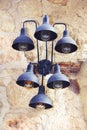 Metal old wall lamp with blue shades on a stone wall background Royalty Free Stock Photo