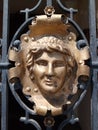 Metal ornament of a face on a gate