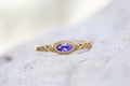 metal ornamental ring with cut amethyste mineral stone