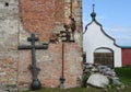 A metal Orthodox cross leaning against the wall of a church.