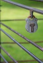 Metal paddlock hanging on a gate