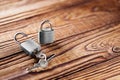 Metal padlock with silvered keys on old wooden background. Estate and security concept with symbol of protection. Royalty Free Stock Photo