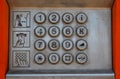 Metal panel of a street payphone with buttons and three pictograms with instructions for use Royalty Free Stock Photo