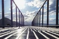 A metal path with handrails looking into the distant mountains on a sunny day