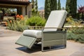 metal patio furnished with a modern outdoor recliner