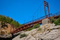 Metal pedestrian bridge over the gorge and mountain river. Yerkopru waterfall, Ermenek river, Mersin province,Turkey Royalty Free Stock Photo