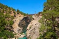 Metal pedestrian bridge over the gorge and mountain river. Yerkopru waterfall, Ermenek river, Mersin province,Turkey Royalty Free Stock Photo