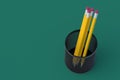 Metal pencil holder on green background. Grid pot. Stationery accessories. Copy space. Top view