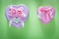 Metal pink heart-shaped present boxes on green background celebr