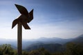 Metal pinwheel with hills landscape