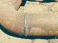 Metal pipe lies on the ground. laying communications for residential buildings underground. rusty, old, dirty metal pipe with a Royalty Free Stock Photo