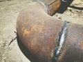Metal pipe lies on the ground. underground communications. water withdrawal. rusty, old, dirty metal pipe with a solder in the Royalty Free Stock Photo