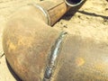 Metal pipe lies on the ground. underground communications. water withdrawal. rusty, old, dirty metal pipe with a solder joint from Royalty Free Stock Photo