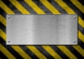 Metal plate background with hazard stripes