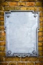 Metal plate on brick wall Royalty Free Stock Photo