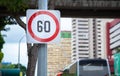 Metal Plate Traffic Sign: Speed limit 60 sign is usually shown as black number in red circle on white rectangular background. It i Royalty Free Stock Photo