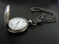 Pocket watch with chain in dark background Royalty Free Stock Photo