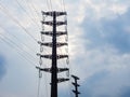 Metal pole with many electrical wires against a cloudy sky background. Power station Royalty Free Stock Photo