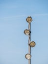Metal pole with spot lights or bulb lights against clear blue sky. Led lamp with directional light