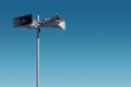 Metal pole with two gray speakers against the sky. Hazard warning system Royalty Free Stock Photo