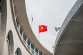 Metal pole with waving banner. Red flag yellow star,Between the two round houses. Rippled texture. National of Vietnam Royalty Free Stock Photo