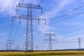 Metal poles electric supports for high-voltage wires in the fields Royalty Free Stock Photo