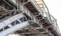 Metal poles pedestrian covered bridge with lots of rivets. Royalty Free Stock Photo